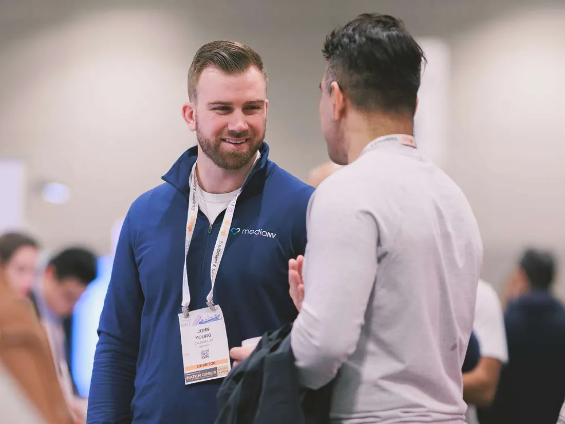 MediaNV team member talking with a dentist at an industry event